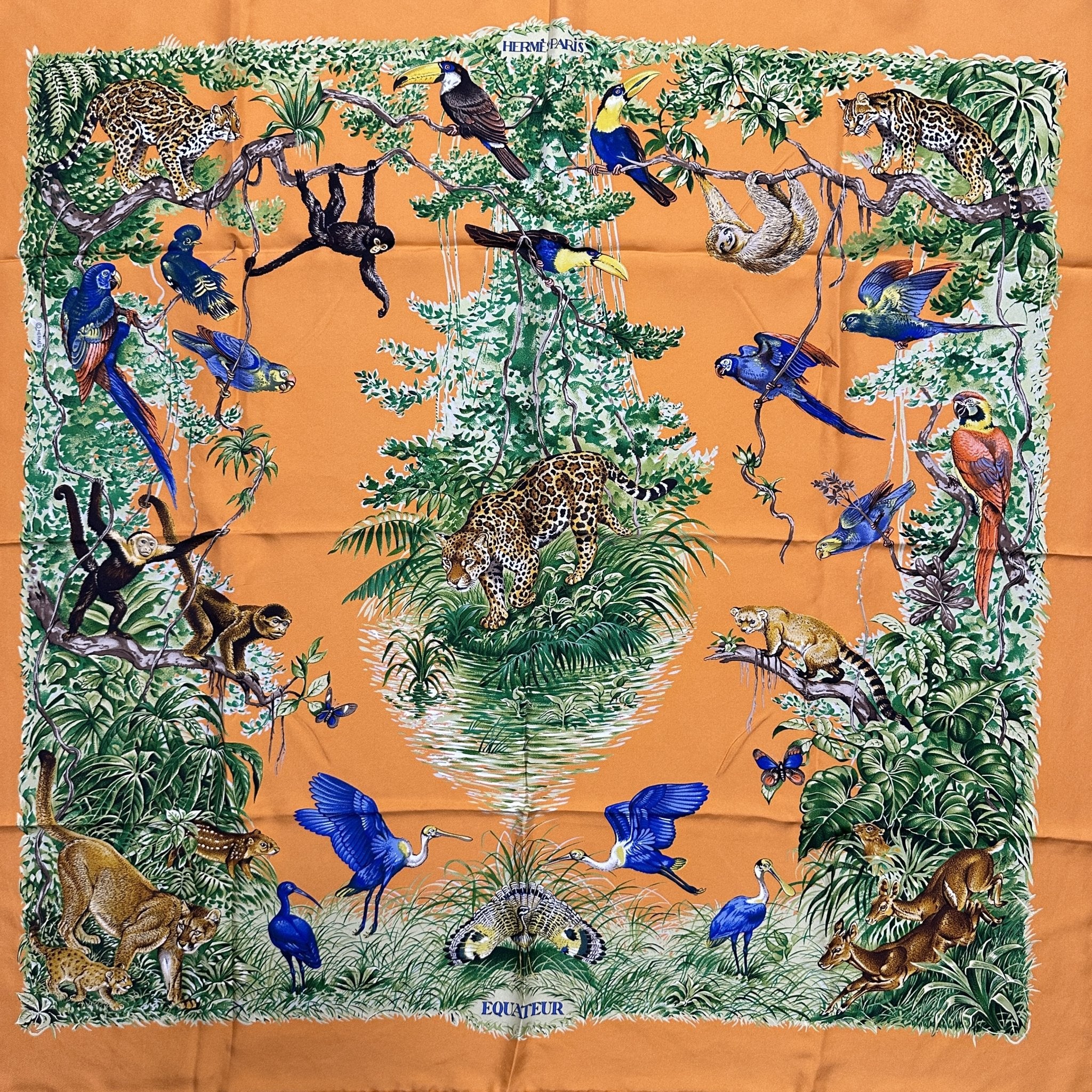 foulard hermes carre equateur modele wash dessin d'animaux de la jungle equatoriale singe félins oiseaux sur fond orange